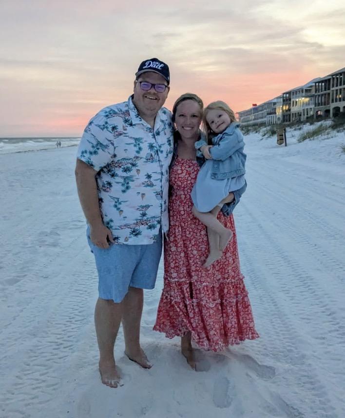 Brady with her family on the beach at sunset