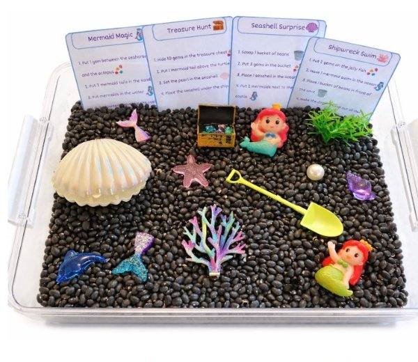 Mermaid sensory kit with black beans, seashells, and mermaid figurines